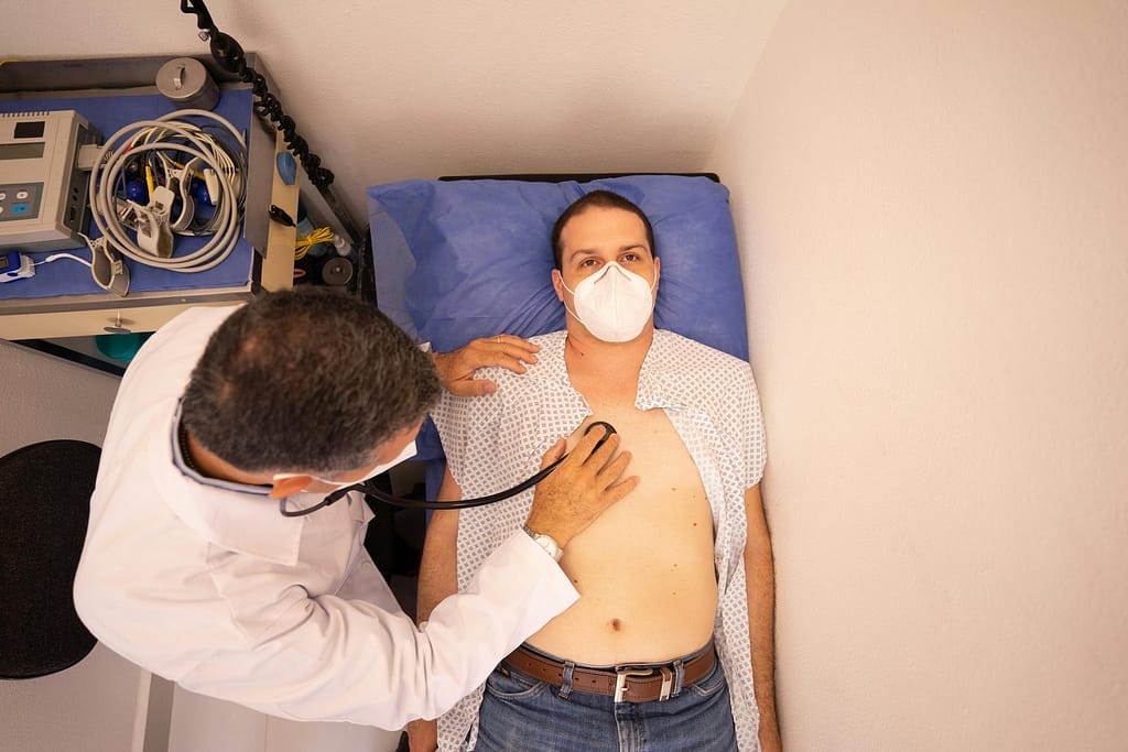 A cardiologist performing a thorough examination on a patient to assess heart health. 